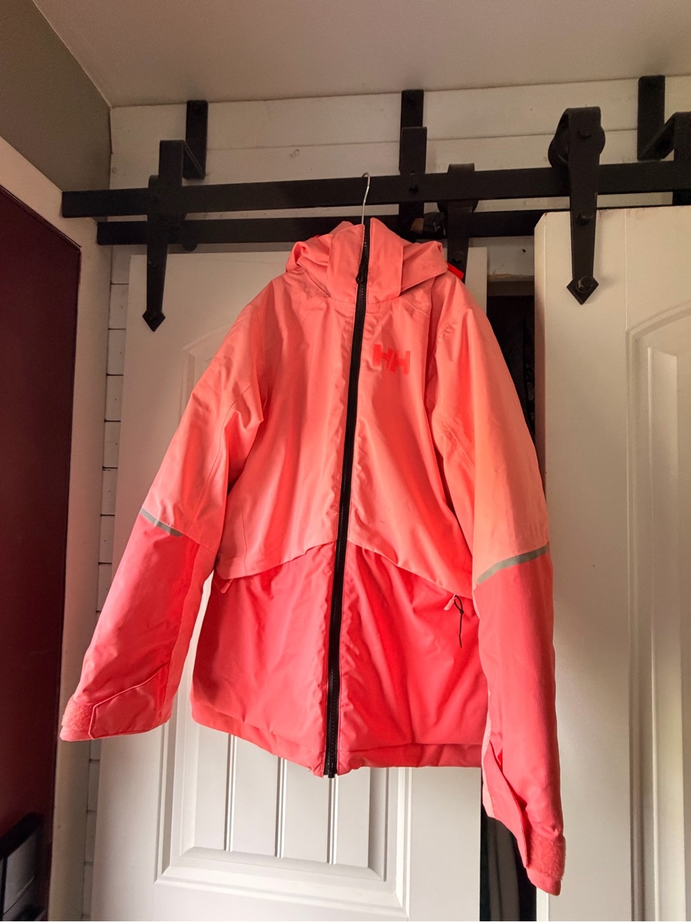 Helly Hansen youth ski jacket in a bright coral/pink color. Size 12 / 152 cm